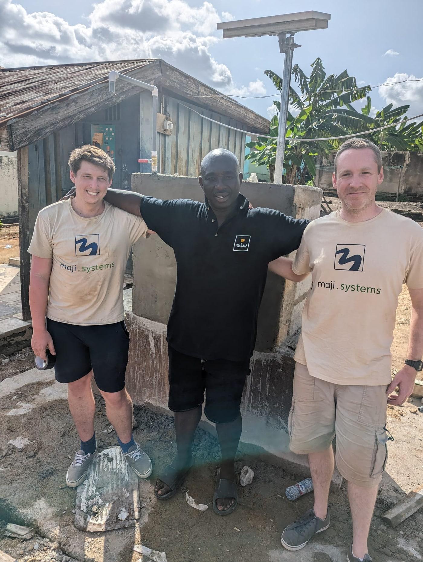 Maji Systems team members with a partner engineer at a dispenser installation site