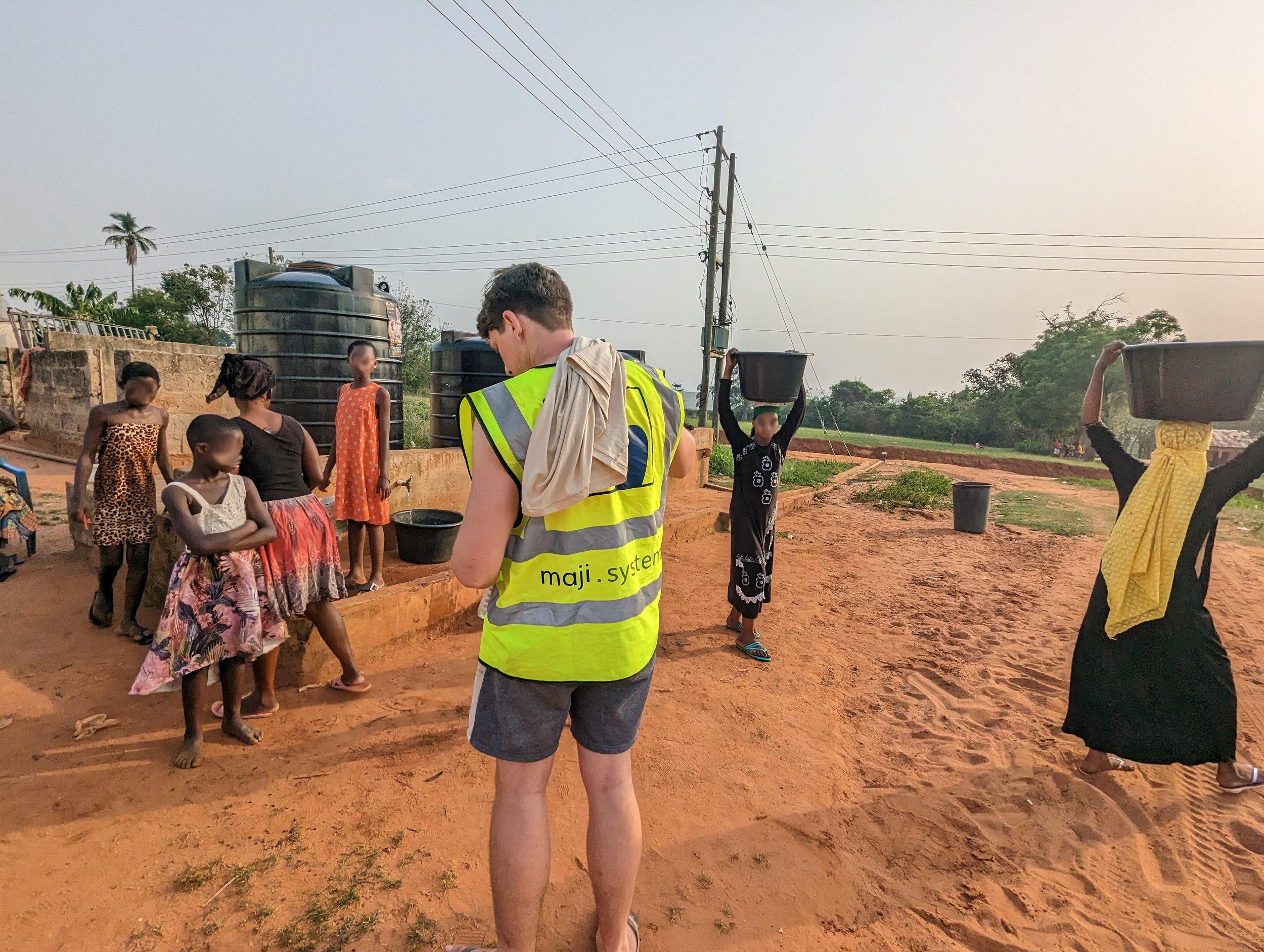 A member of the Maji Systems team with a Community Dispenser installation
