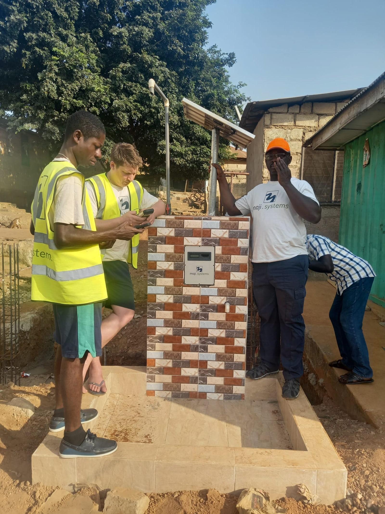 William Oteng-Mensah and the OM Water Systems team commissioning a standpipe dispenser installation in Kumasi, Ghana