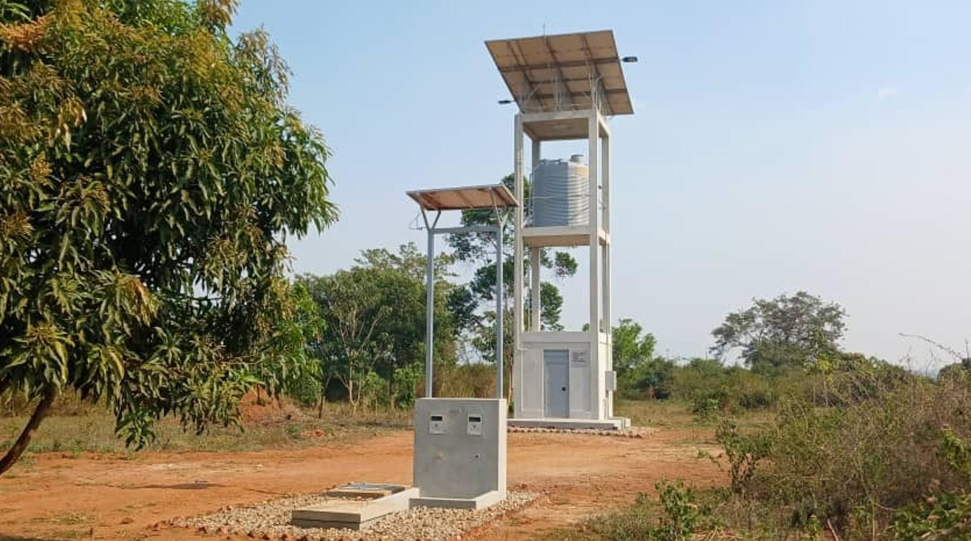 A solar-powered water tower with an integrated Maji Community Dispenser at a rural water point