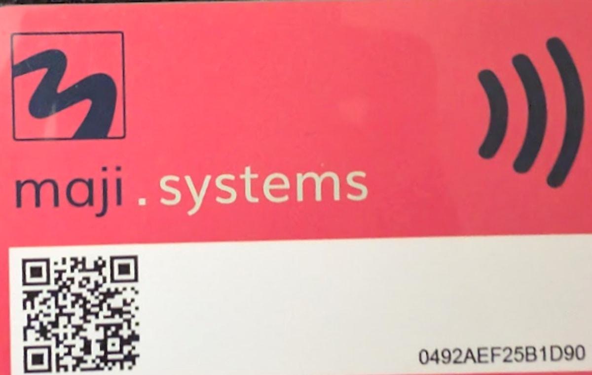 A red Maji Systems Engineer Card, used to configure a dispenser from the app